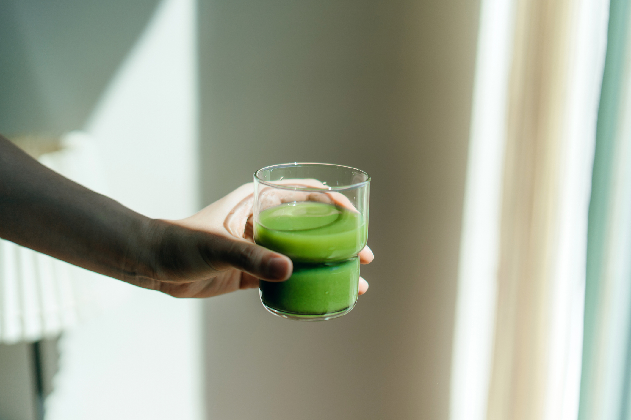 Someone holding a green garden savoury smoothie